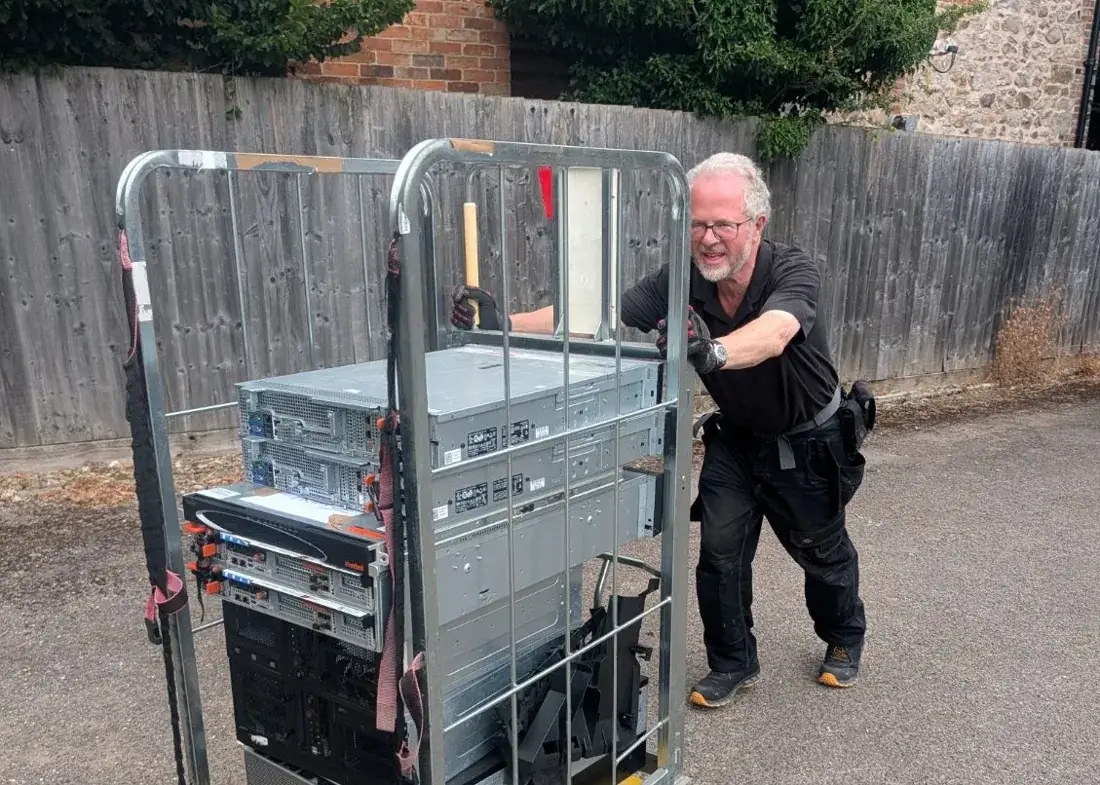 A Terraguard team member wheeling a trolley of servers to the collection van